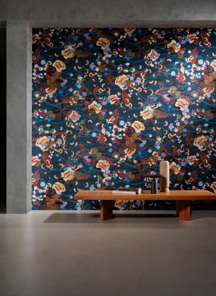 Arte Koi: blüten und Fische auf dunkelblauem Grund hinter einer Holzbank.